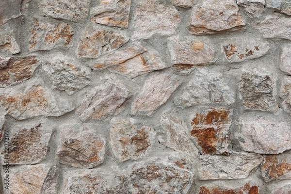 Fototapeta Fragment of a wall from a chipped stone