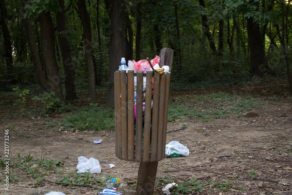 Fototapeta Filled trash can. Pollution