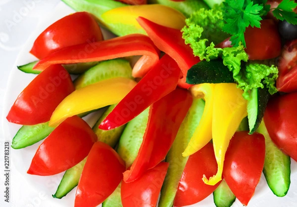 Obraz sliced ​​vegetables on a white plate