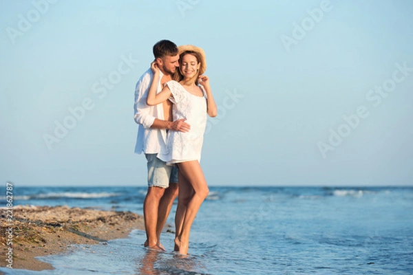 Fototapeta Young couple spending time together on beach