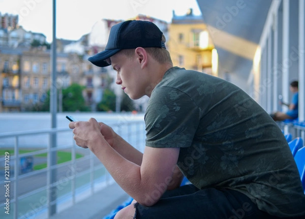 Obraz Young man checking his phone