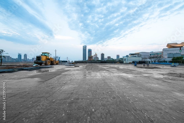 Obraz excavator in construction site on sunset sky background