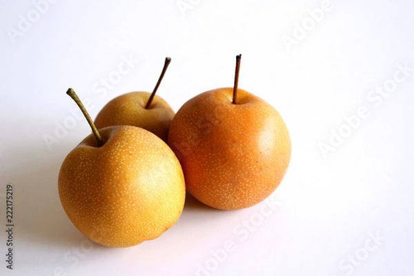 Fototapeta Whole Chinese pear or Nashi pear with stem on white background. Food concept.