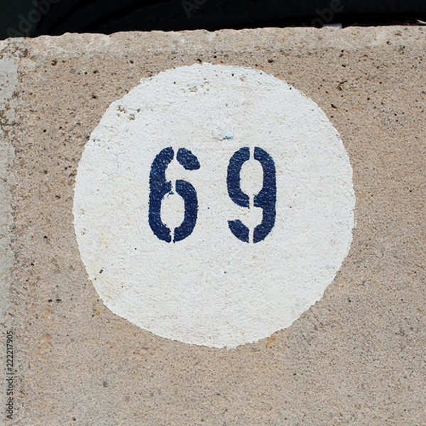 Fototapeta Number 69 painted on a concrete floor