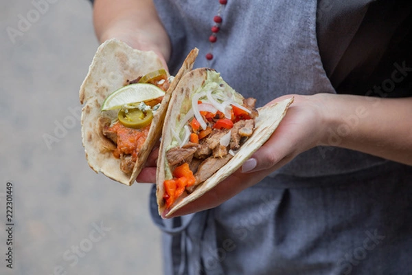 Fototapeta Takos with grilled chicken and guacamole and grilled pork and savory vegetable salsa on the grill.