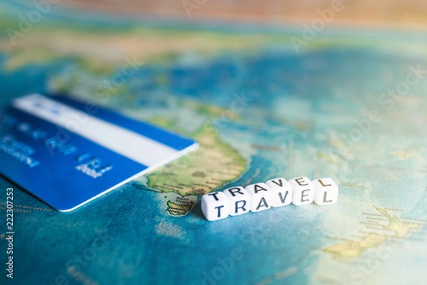 Fototapeta Credit card on world map with "TRAVEL" alphabet cube letter