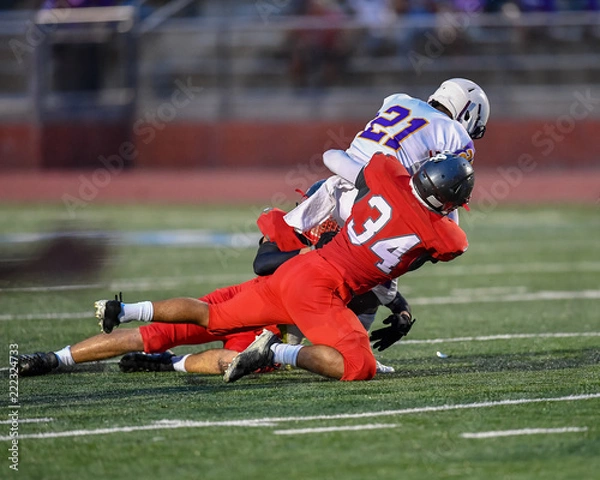 Fototapeta Football player making an amazing play during a game