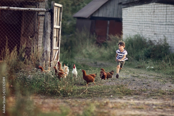 Fototapeta boy running on the path in the village