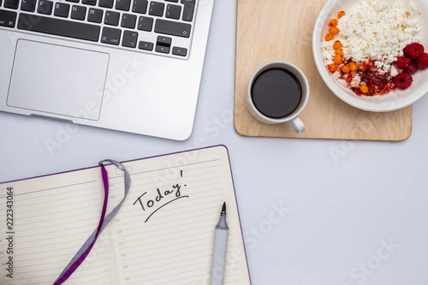 Fototapeta Top view with copy space, Office white desk table with computer, coffee cup espresso, curd in a plate with raspberry jam, breakfast