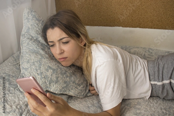 Fototapeta Nervous woman checking phone