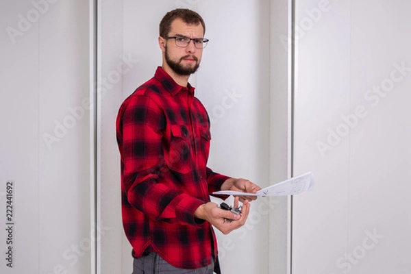 Obraz Frustrated man reading instruction
