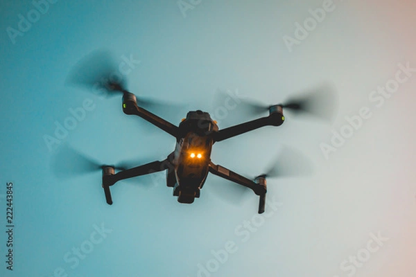 Obraz darken drone on blue warm background