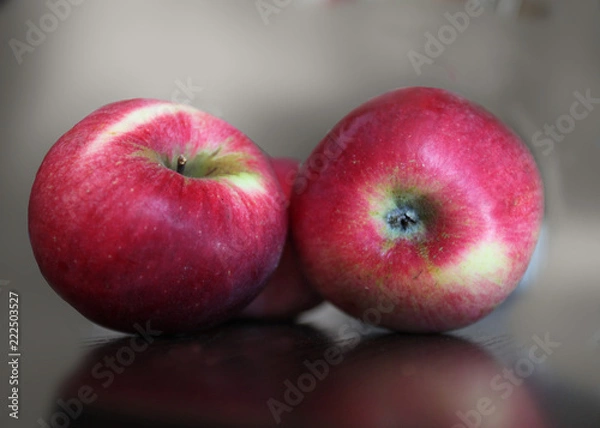 Obraz Three red ripe apples lying on a table