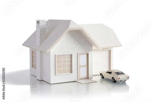 Fototapeta House miniature with car isolated in white background for real estate and construction concepts. House miniature designed and created by contributor
