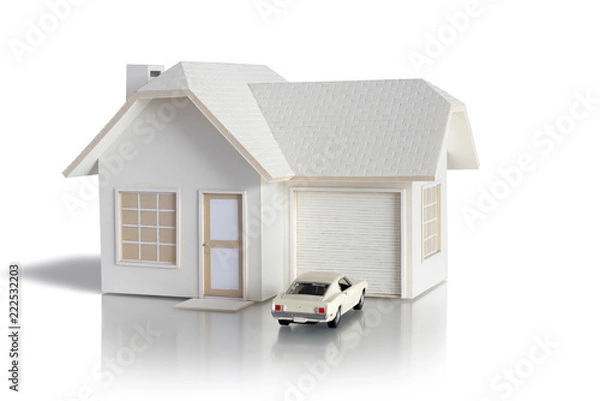 Fototapeta House miniature with car isolated in white background for real estate and construction concepts. House miniature designed and created by contributor