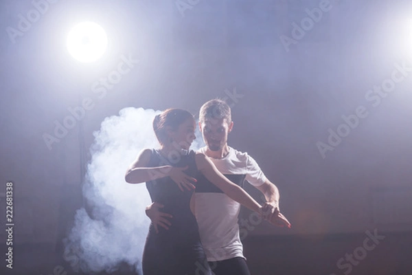 Fototapeta Active happy adults dancing bachata together in dance class