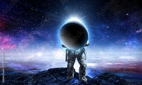 Fototapeta Spaceman carry big planet. Mixed media
