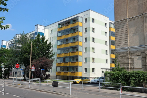 Obraz Typical modernized residential buildings in Leipzig city center with blue sky, architecture from the GDR from the 70s and 80s of the last century