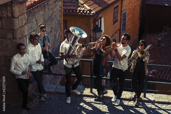 Fototapeta Zespół jazzowy grupa muzyków z instrumentami wiatrowymi grającymi na ulicy miasta.