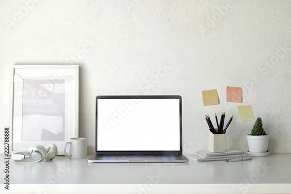 Fototapeta Mockup poster empty frame with blank screen laptop on workspace table