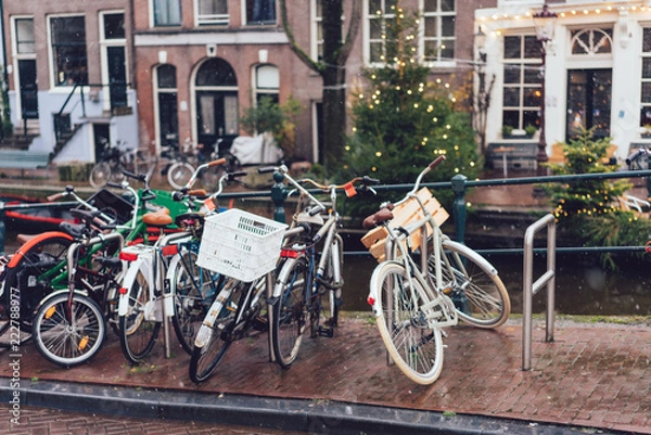 Fototapeta Bicycles lining a bridge over the canals of Amsterdam