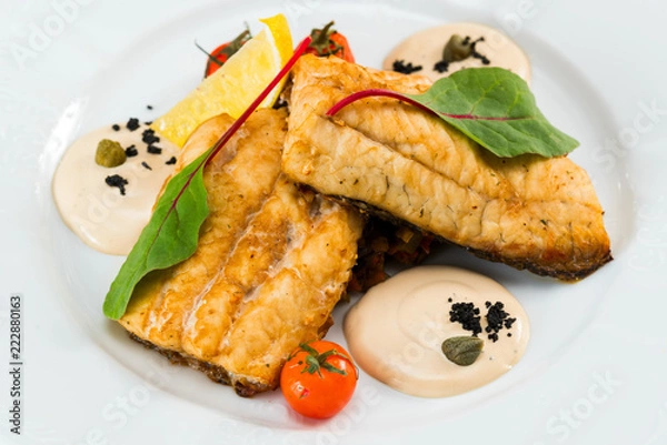 Obraz fried fish fillet with vegetables with parmesan sauce
