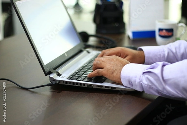 Fototapeta male hands typing on a laptop