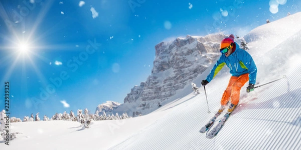 Obraz Skier skiing downhill in high mountains