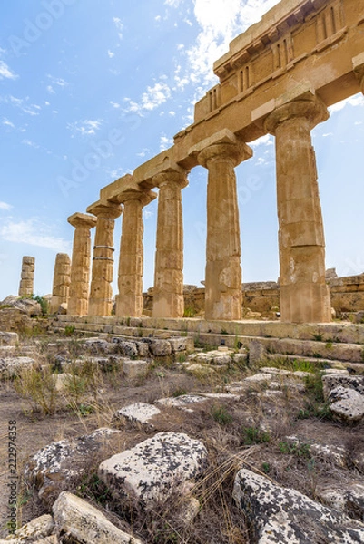 Fototapeta Ruins of the Temple C dedicated to Apollo, inside the archaeological park of Selinunte, an ancient Greek city on a seaside hill in the south west coast of Sicily.