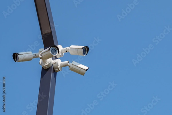 Obraz Multi-angle CCTV surveillance security camera video equipment on the blue sky background