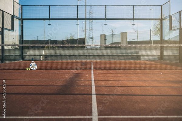 Fototapeta Padel blade racket resting on the net