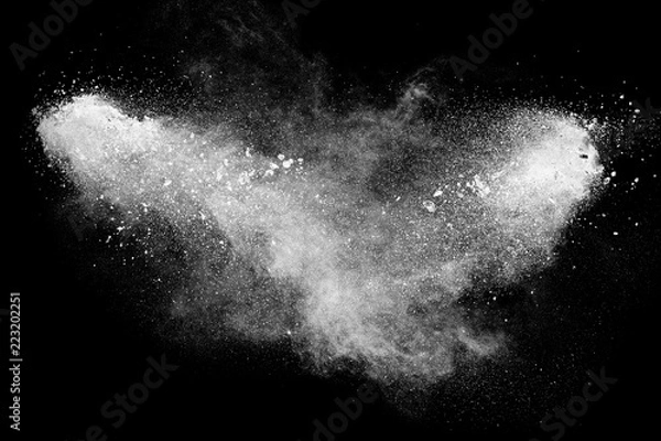 Fototapeta Bizarre forms of white powder explosion cloud against black background.White dust particles splash.