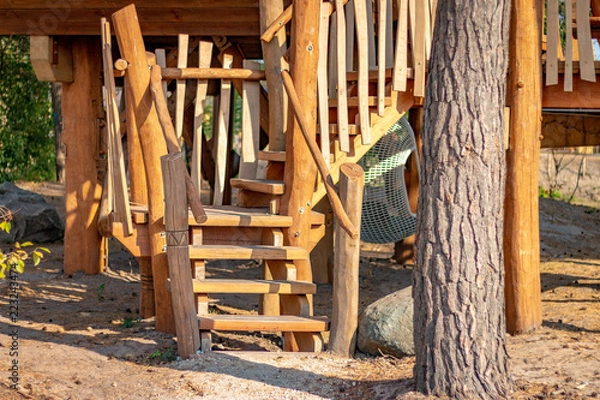 Fototapeta HILVARENBEEK, NETHERLANDS - AUGUST 1 2018: Wooden log cabins serve as a holiday home in Dutch zoo during the hot summer days