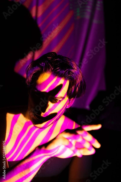 Fototapeta Cinematic portrait of man in yellow and purple lines, projecto