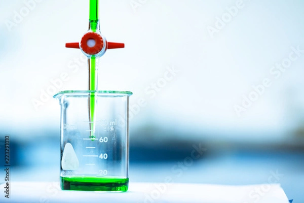 Fototapeta Tritration and bigger with green liquid .