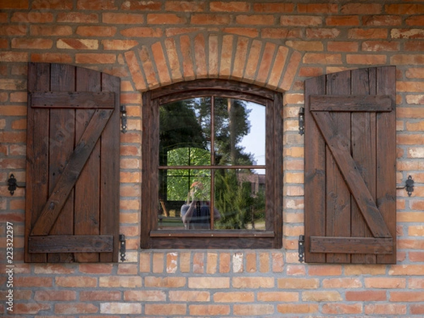 Obraz Window with shutters on a brick wall