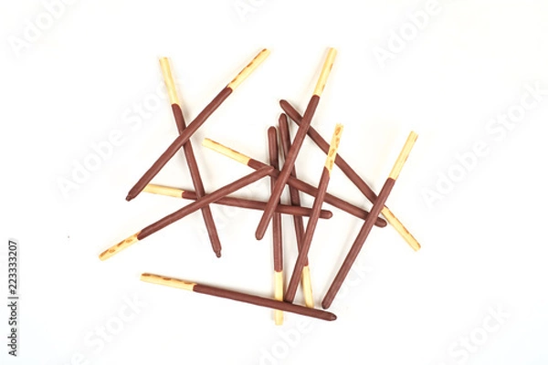 Fototapeta Biscuit sticks in chocolate coating on white background. Chocolate, cookies, biscuits coated bar.