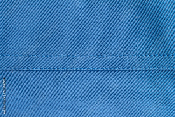 Obraz Ściegi na niebieskim materiale.