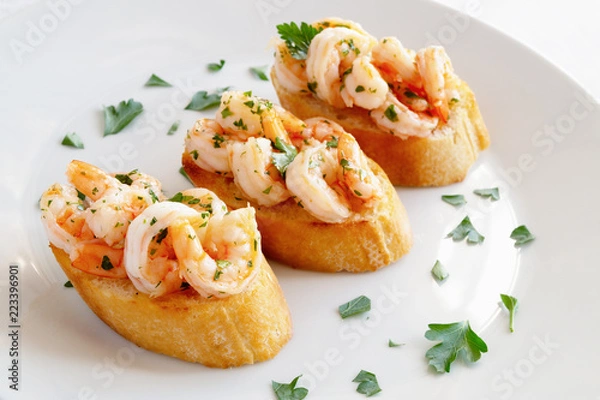 Fototapeta fried bread with fried in garlic oil prawns decorated with parsley