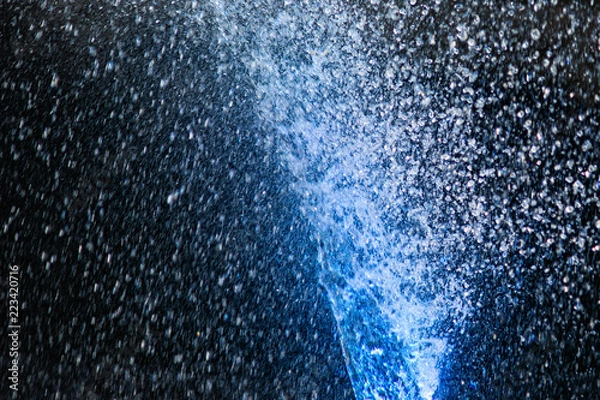 Fototapeta Illuminated water jets. Blue color