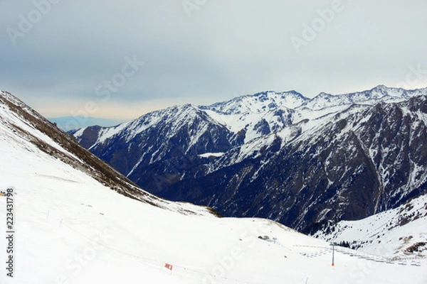 Obraz high snowy mountains in cloudy day