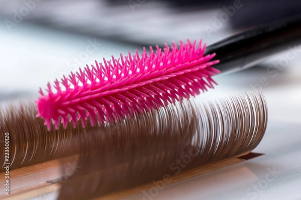 Fototapeta Eyelash brown extension procedure. Set Lashes close up pink comb