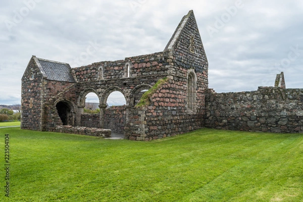 Obraz St Mary's Nunnery, Isle of Iona, Scotland, old building remains, on a cloudy day, surrounded by the green grass.