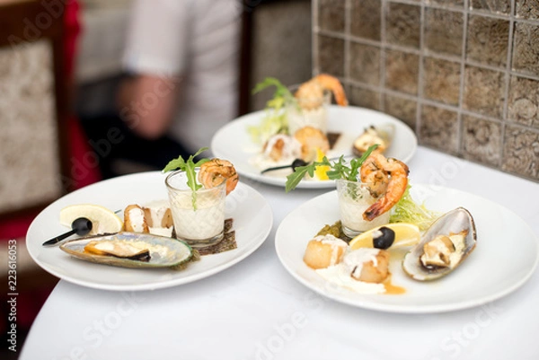 Fototapeta Seafood sets at local restaurant, fine dining, Fresh seafood platter with , mussels and on plate with tartar sauce