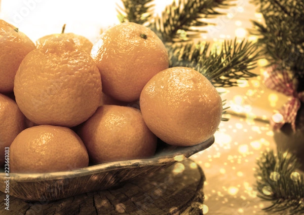 Fototapeta Decorative composition with tangerines. The concept of Christmas holidays.Image in sepia tones.