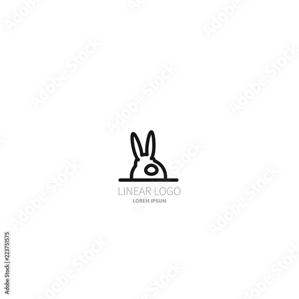 Fototapeta Logo of rabbit. The hare sits with its back. The symbol is made in a linear-minimalist style
