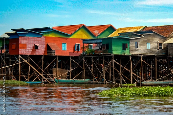Fototapeta Colorful, multicolored stilt houses line the edge of Lake Tonle Sap in the floating village of Kampong Khleang, near Siem Reap in Cambodia
