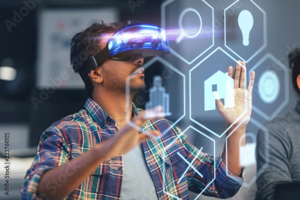 Fototapeta deadline, augmented reality and technology concept - creative man with virtual headset or vr glasses and hologram of menu icons at night office