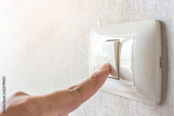 Fototapeta Concept save energy. Hand turning off switch