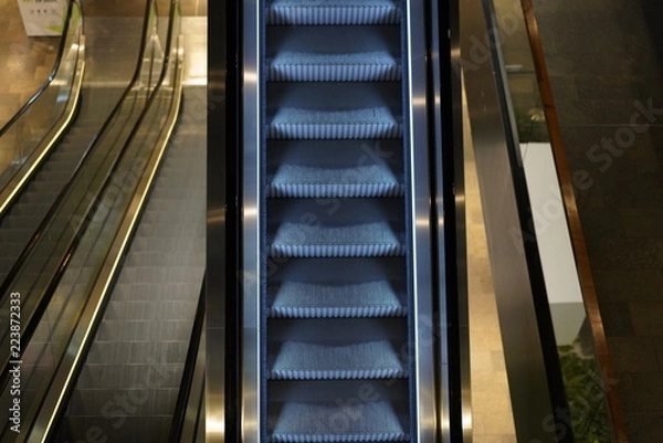 Fototapeta Illuminated escalator in a shopping mall